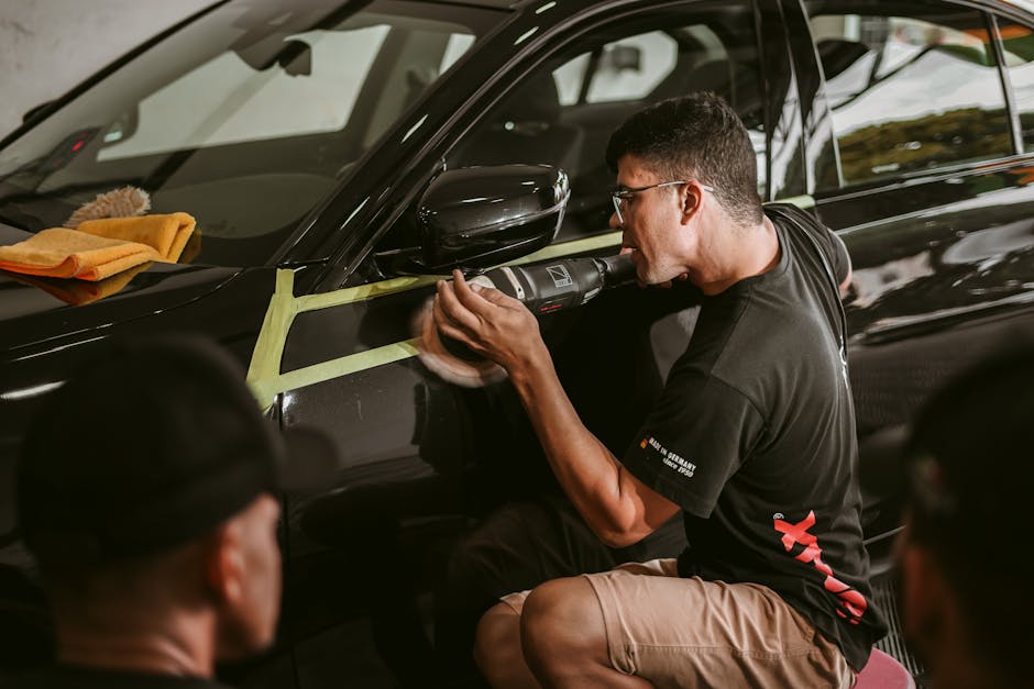 Professional detailer applying ceramic coating to a vehicle