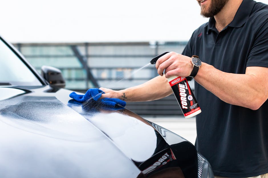Microfiber cloth wiping car exterior